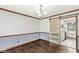 Bright dining room features hardwood floors, wainscoting, modern lighting, and a sliding barn door at 4152 S Creekside Dr, New Palestine, IN 46163
