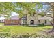 Charming two-story home with stone and brick exterior and well-manicured lawn at 4152 S Creekside Dr, New Palestine, IN 46163