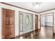 Bright foyer with hardwood floors, a decorative front door, and wood trim at 4152 S Creekside Dr, New Palestine, IN 46163