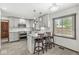 Updated kitchen features white cabinets, stainless steel appliances, and a kitchen island with seating at 4152 S Creekside Dr, New Palestine, IN 46163