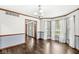 Bright living room with hardwood floors, wainscoting, and large windows providing natural light at 4152 S Creekside Dr, New Palestine, IN 46163