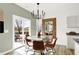 Bright dining area features a glass table, stylish chairs, and a sliding door leading to the patio at 4205 Malvern Way, Indianapolis, IN 46235