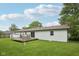 Well-maintained backyard with a wooden deck, chairs, table, green lawn and white siding at 431 Fox Cir, Noblesville, IN 46060