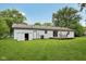 Large backyard with green grass, a shed, patio furniture on the deck, and a well-maintained lawn at 431 Fox Cir, Noblesville, IN 46060