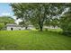 Expansive backyard view showcasing a lush lawn, mature trees, and the home's exterior at 431 Fox Cir, Noblesville, IN 46060