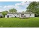 Spacious backyard featuring a storage shed, wooden deck with furniture, and well-kept lawn at 431 Fox Cir, Noblesville, IN 46060