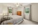 Comfortable bedroom featuring carpet flooring, ceiling fan, and large windows at 431 Fox Cir, Noblesville, IN 46060