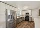 Modern kitchen featuring stainless steel appliances, white cabinets, and laminate flooring at 431 Fox Cir, Noblesville, IN 46060