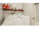 Bright laundry room with side-by-side washer and dryer, storage shelf, and neutral paint at 431 Fox Cir, Noblesville, IN 46060