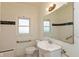 Clean bathroom with white tiled walls, black accents, and modern fixtures at 4710 Hinesley Ave, Indianapolis, IN 46208