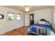 Bright bedroom with hardwood floors and two windows providing natural light at 4710 Hinesley Ave, Indianapolis, IN 46208