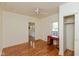 Bright bedroom featuring hardwood floors, a ceiling fan, and a closet at 4710 Hinesley Ave, Indianapolis, IN 46208