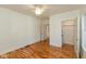 Bedroom with hardwood floors, ceiling fan, and a laundry nook at 4710 Hinesley Ave, Indianapolis, IN 46208
