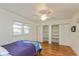 Comfortable bedroom with hardwood floors, ceiling fan, and closet with shelving at 4710 Hinesley Ave, Indianapolis, IN 46208
