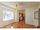 Dining area with hardwood floors, bay window, and an open view of the kitchen at 4710 Hinesley Ave, Indianapolis, IN 46208