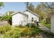 Side of the house with an attached porch and well-maintained landscaping at 4710 Hinesley Ave, Indianapolis, IN 46208