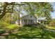 Landscaped front yard with a ramp leading to the covered porch of this charming home at 4710 Hinesley Ave, Indianapolis, IN 46208