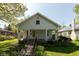 Charming home with a covered front porch, featuring a walkway and garden at 4710 Hinesley Ave, Indianapolis, IN 46208