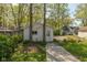 Exterior view of the detached garage with a concrete pathway and a white door at 4710 Hinesley Ave, Indianapolis, IN 46208