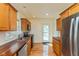 Kitchen with stainless steel appliances, wooden cabinets, and hardwood floors at 4710 Hinesley Ave, Indianapolis, IN 46208