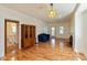 Open floor plan featuring hardwood floors, access to bathroom and large windows at 4710 Hinesley Ave, Indianapolis, IN 46208