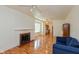 Spacious living room with hardwood floors, fireplace, and access to kitchen at 4710 Hinesley Ave, Indianapolis, IN 46208