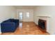 Bright living room features hardwood floors, a fireplace, and a comfortable blue sofa at 4710 Hinesley Ave, Indianapolis, IN 46208