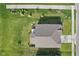 Aerial view of a home, showcasing the roof, landscaping, and surrounding greenery at 4985 W Burrel Ln, New Palestine, IN 46163