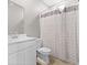 Bathroom features modern fixtures, a white vanity, and a shower with a decorative gray shower curtain at 4985 W Burrel Ln, New Palestine, IN 46163