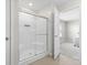 The bathroom features a shower with sliding glass doors, complemented by tiled flooring at 4985 W Burrel Ln, New Palestine, IN 46163