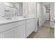 This bathroom showcases a double sink vanity, elegant faucets, and tiled flooring at 4985 W Burrel Ln, New Palestine, IN 46163