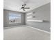 Spacious bedroom featuring a ceiling fan and modern floating shelves for a contemporary touch at 4985 W Burrel Ln, New Palestine, IN 46163