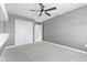 Neutral bedroom featuring ample closet space and a ceiling fan for added comfort at 4985 W Burrel Ln, New Palestine, IN 46163