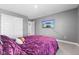 Well-lit bedroom features a ceiling fan and a mounted TV for relaxing and watching your favorite shows at 4985 W Burrel Ln, New Palestine, IN 46163