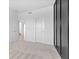 A carpeted room featuring a view to the hallway with a closet and a large open window at 4985 W Burrel Ln, New Palestine, IN 46163