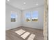 Sunlit bedroom with three windows and a sliding glass door, offering views of the outside at 4985 W Burrel Ln, New Palestine, IN 46163