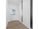 Bright entryway featuring neutral walls, modern flooring, and a glass-paneled front door at 4985 W Burrel Ln, New Palestine, IN 46163