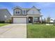 Charming two-story home with a brick and gray exterior, large driveway, and well-maintained lawn at 4985 W Burrel Ln, New Palestine, IN 46163