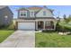 Charming home with a manicured lawn, driveway, and attached two-car garage at 4985 W Burrel Ln, New Palestine, IN 46163