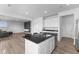Open layout showcasing kitchen island and living room with sleek design elements at 4985 W Burrel Ln, New Palestine, IN 46163