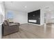Bright living room with sleek flooring, a modern media wall, and large windows at 4985 W Burrel Ln, New Palestine, IN 46163