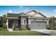Charming home featuring blue siding, brick accents, and a gray garage door on a sunny day at 5308 W Glenview Dr, McCordsville, IN 46055