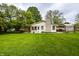 Spacious backyard featuring a well-kept lawn, patio, and beautiful landscaping at 5450 Fenmore Rd, Indianapolis, IN 46228