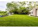Well-maintained backyard with a lush lawn, garden, shed, and patio space for relaxation at 5450 Fenmore Rd, Indianapolis, IN 46228