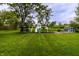 Expansive backyard featuring a playground, shed, and garden, perfect for Gathering enjoyment at 5450 Fenmore Rd, Indianapolis, IN 46228