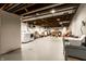 Large basement area with exposed ceiling, laundry area, and plenty of open space at 5450 Fenmore Rd, Indianapolis, IN 46228