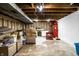 Unfinished basement area with exposed ceiling, packed boxes, and utility area at 5450 Fenmore Rd, Indianapolis, IN 46228