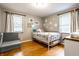 bedroom with a twin bed, hardwood floor and decorative wall stickers at 5450 Fenmore Rd, Indianapolis, IN 46228