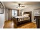 Serene bedroom with hardwood floors, ceiling fan, and lots of natural light at 5450 Fenmore Rd, Indianapolis, IN 46228