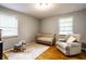 Cozy Bedroom with hardwood floors and a comfortable armchair, perfect for a new baby at 5450 Fenmore Rd, Indianapolis, IN 46228